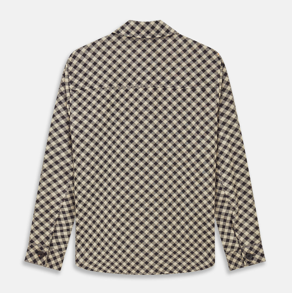 The Turnbull & Asser Black Gingham Check Wool Blend Somerset Overshirt features long sleeves, two chest flap pockets with buttons, and a black-and-beige check pattern. Shown laid flat on a white background; ideal as transitional outerwear.