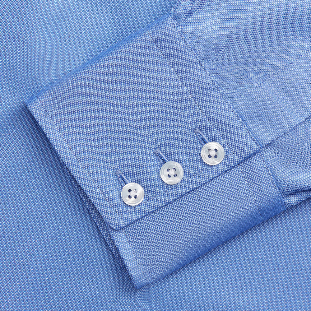 The World Is Not Enough Blue Cotton Istanbul Shirt by Turnbull & Asser, as seen on James Bond, features long sleeves, white buttons, a classic collar, and buttoned cuffs, shown against a plain white background.