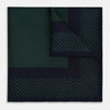 View 1 of product The Turnbull & Asser Navy and Green Dot Silk Pocket Square features dense green polka dots on navy silk, a solid navy border, and a band of spaced green dots—expertly handmade with precise finishing for an elegant look.