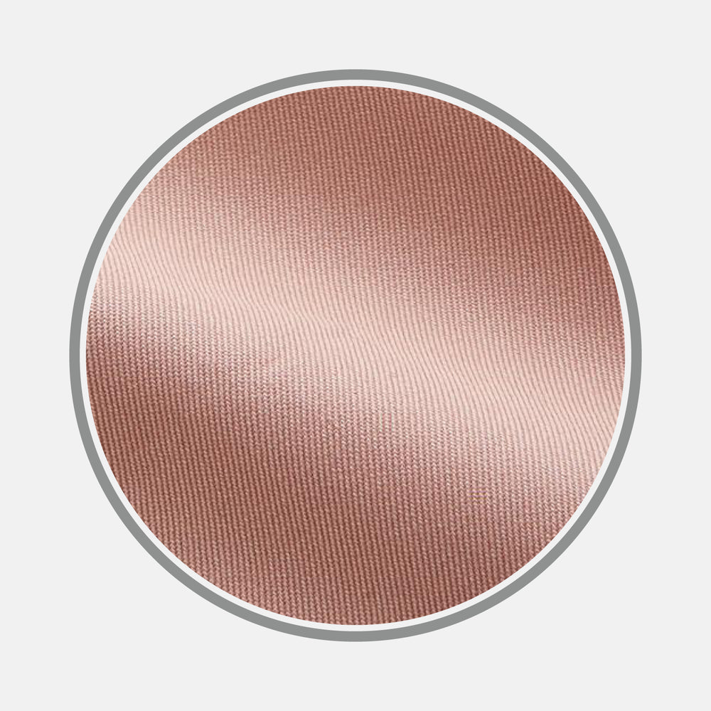 Close-up of Turnbull & Asser’s Plain Pink Piece Dyed Cotton Fabric inside a circular frame, highlighting its fine texture, smooth finish, and soft light reflection.