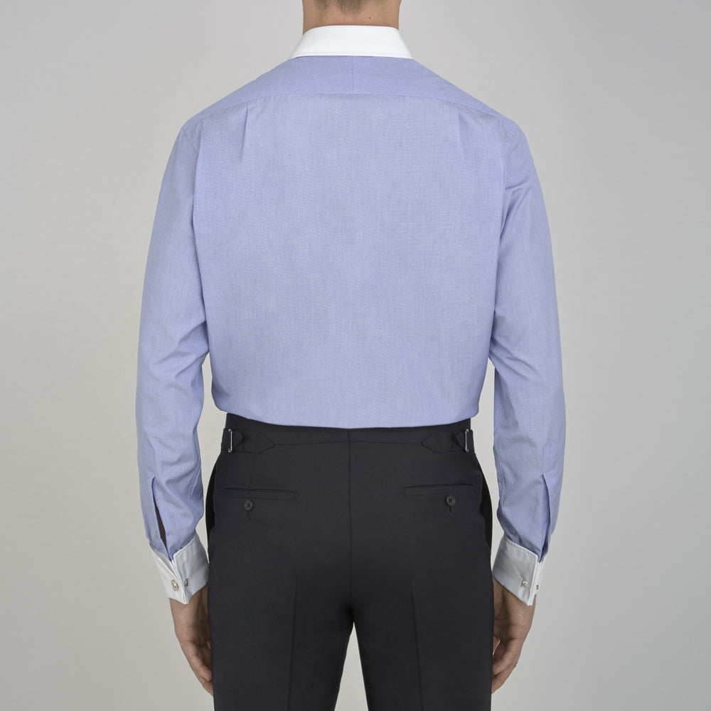 The Wall Street Shirt with White T&A Collar by Turnbull & Asser, as seen on Gordon Gekko, is folded neatly to showcase its light purple color, crisp French cuffs, and iconic contrasting collar against a plain background.