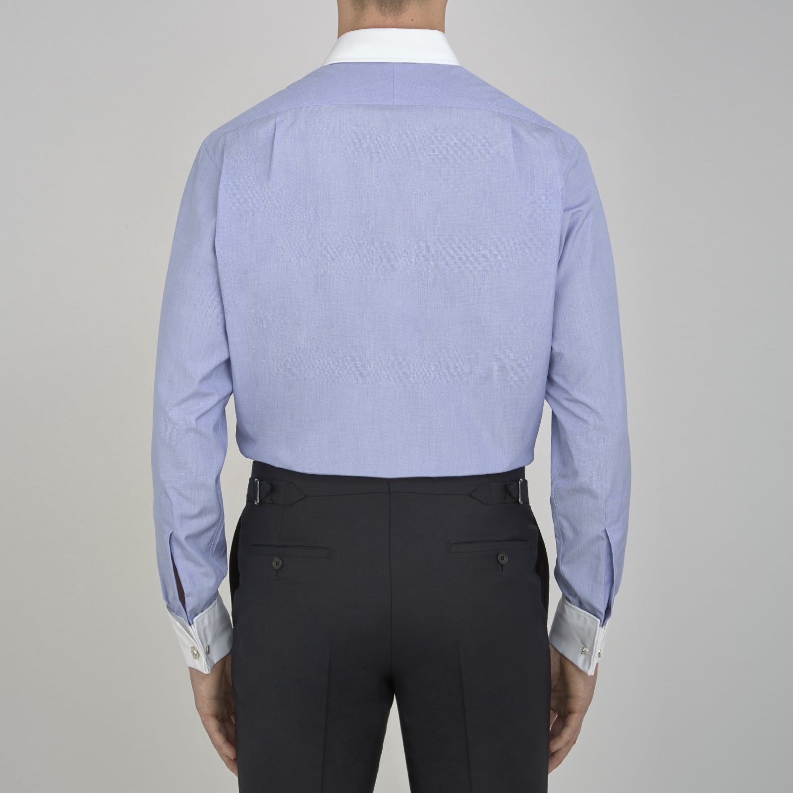 View 3 of product The Wall Street Shirt with White T&A Collar by Turnbull & Asser, as seen on Gordon Gekko, is folded neatly to showcase its light purple color, crisp French cuffs, and iconic contrasting collar against a plain background.