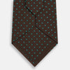 View 3 of product The Turnbull & Asser Green and Brown Micro Dot Silk Tie is shown rolled up, displaying its evenly spaced micro dot pattern against a plain white background.
