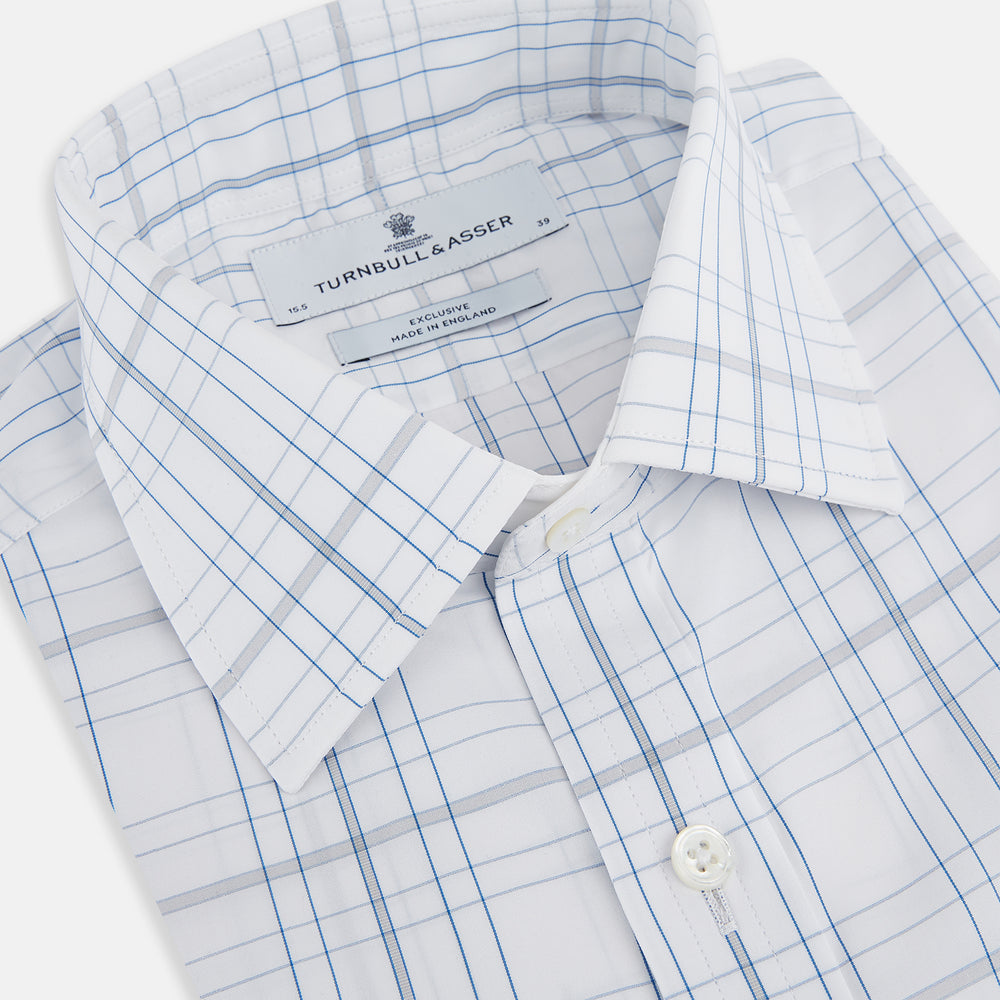 The Turnbull & Asser Blue and Grey Multi Check Mayfair Shirt features a T&A collar, cuffed long sleeves, and a light blue and gray plaid pattern on white.