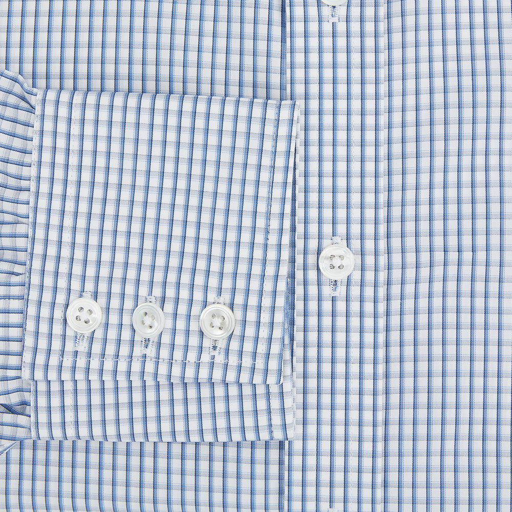 The Sky Blue Micro Shadow Check Mayfair Shirt by Turnbull & Asser features long sleeves, a classic collar, buttoned cuffs, and a light blue and white micro check pattern—showcasing refined British craftsmanship.