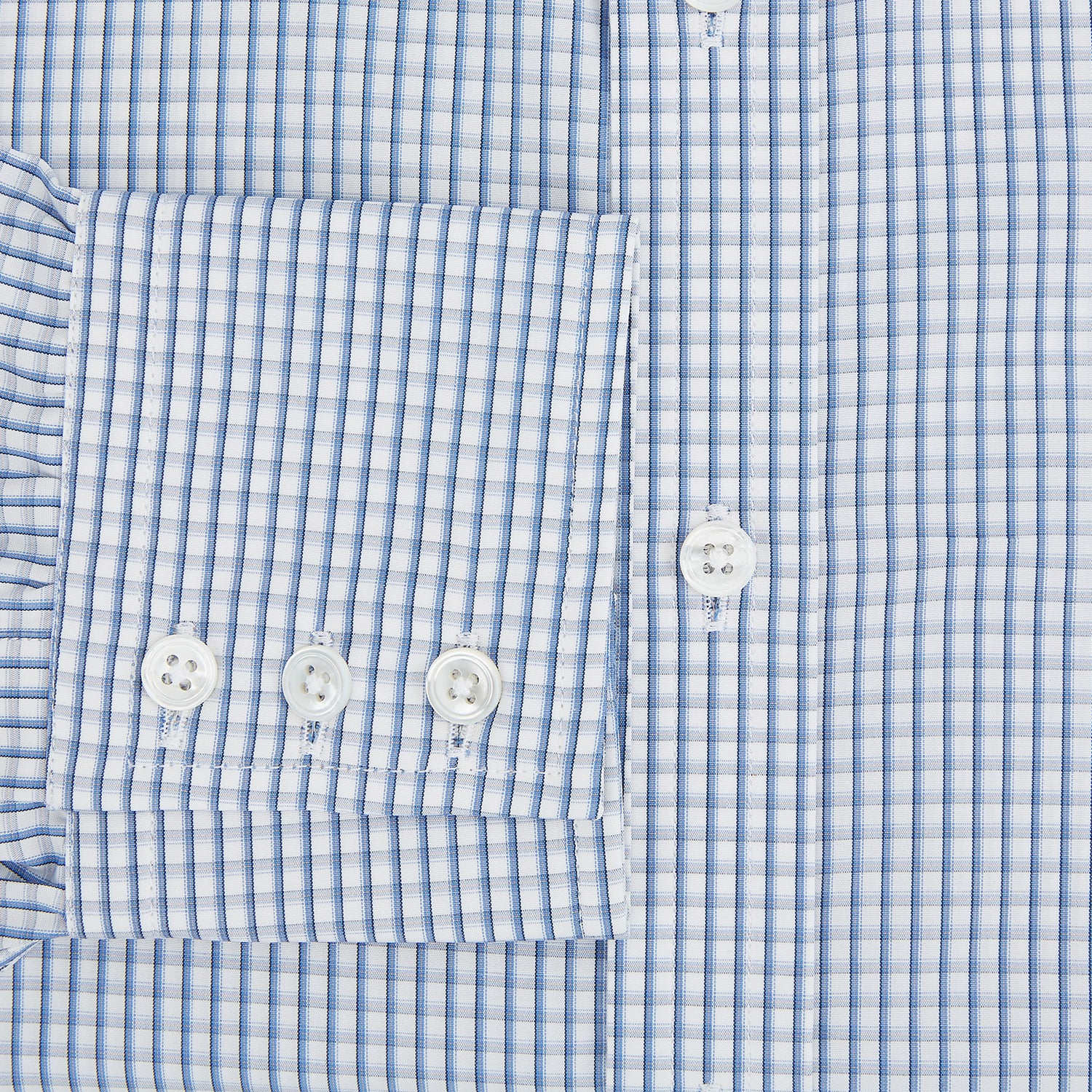 View 4 of product The Sky Blue Micro Shadow Check Mayfair Shirt by Turnbull & Asser features long sleeves, a classic collar, buttoned cuffs, and a light blue and white micro check pattern—showcasing refined British craftsmanship.