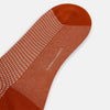 View 3 of product The Rose Houndstooth Mid-Length Sock by Turnbull & Asser, shown in red and white with solid red toe, heel, and cuff, is displayed on a plain white background.