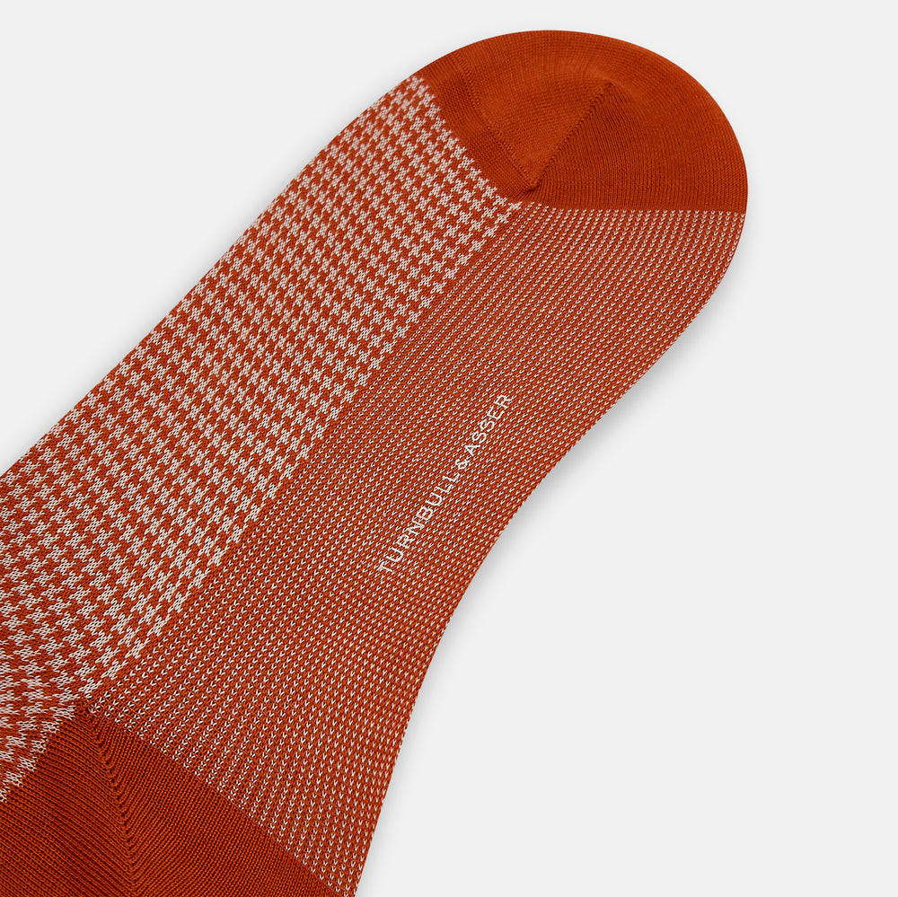 The Rose Houndstooth Mid-Length Sock by Turnbull & Asser, shown in red and white with solid red toe, heel, and cuff, is displayed on a plain white background.