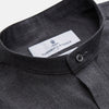 View 2 of product The Turnbull & Asser Charcoal Cotton Blend Weekend Fit Blake Shirt is a long-sleeve, stand-collar shirt with white buttons. Its minimalist design, with no pockets or patterns, makes it perfect for casual wear. Displayed flat on a white background.