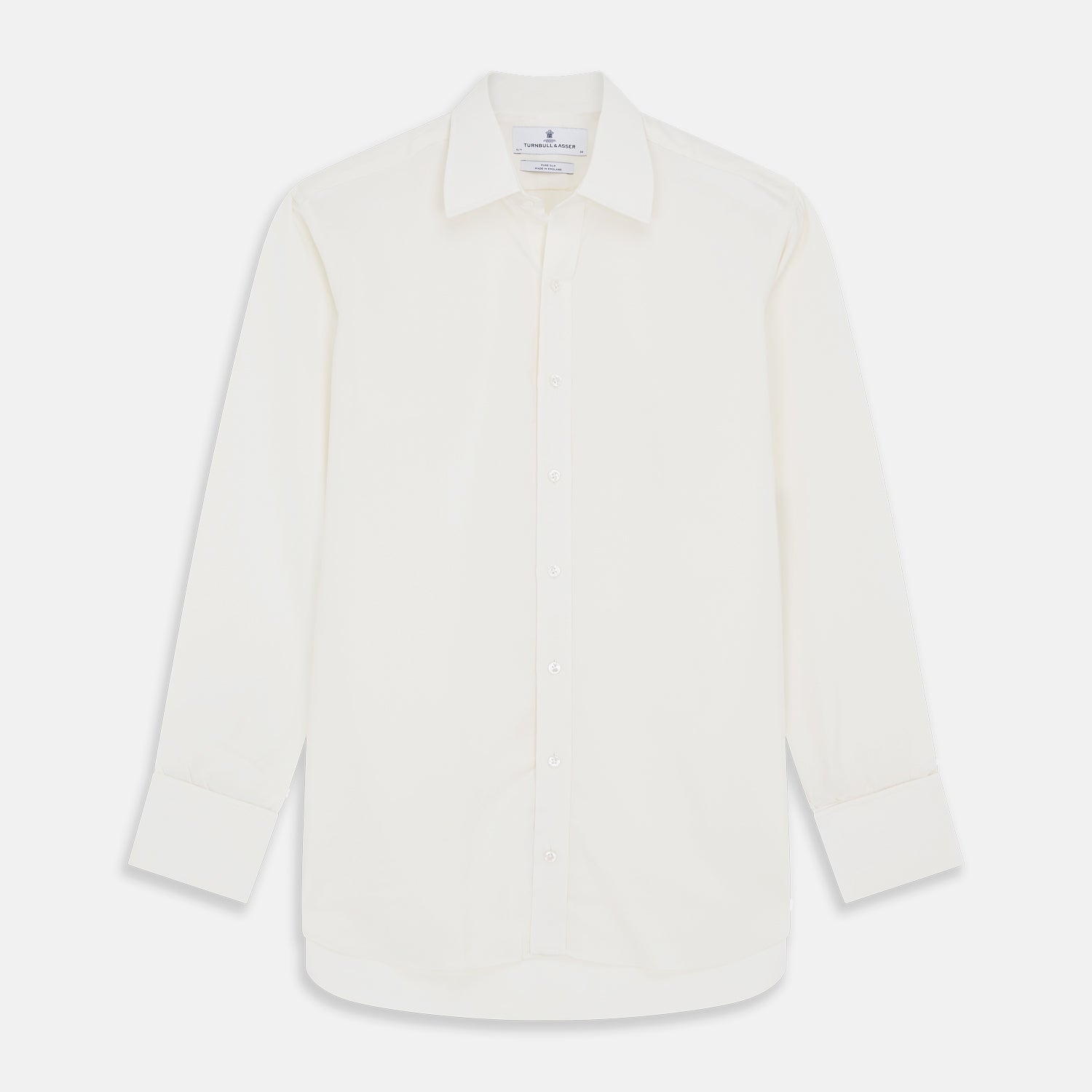View 1 of product The Cream Silk Whitby Shirt by Turnbull & Asser features a pointed collar, buttoned front and cuffs, and long sleeves, shown in Whitby Fit and laid flat on a white background.