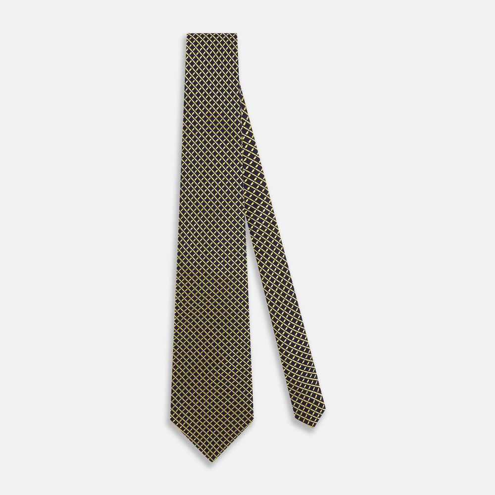 The Turnbull & Asser Yellow and Navy Diamond Silk Tie, with a refined yellow and light blue grid pattern, is elegantly rolled up on a plain white background.