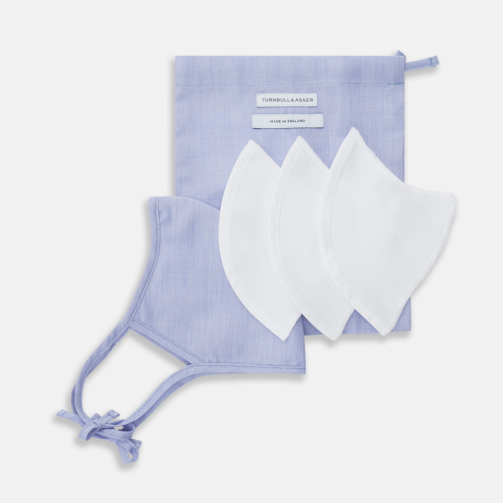 The Turnbull & Asser Plain Pale Blue Commuter Mask with 3 Viroformula™ filters features adjustable ear loops and side ties—ideal for daily use, shown against a white background.