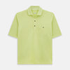 View 1 of product The Turnbull & Asser Lime Green Polo Shirt features a cotton jersey build, short sleeves, a collar, three brown buttons on the placket, and a chest pocket with a button. Shirt shown laid flat on a white background.