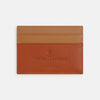 View 1 of product The TAN LEATHER CARD CASE by Turnbull & Asser is a minimalist brown leather wallet with two slots and "Turnbull & Asser Made in England" embossed on the front.