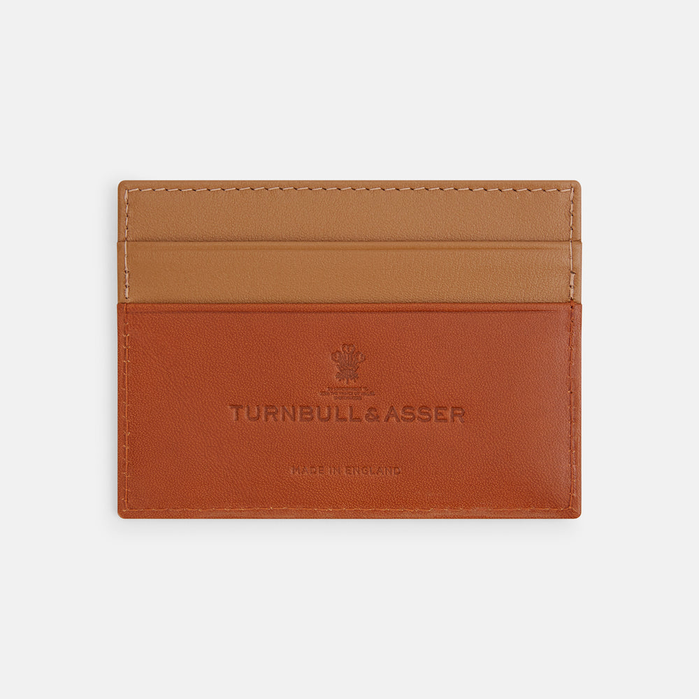 The TAN LEATHER CARD CASE by Turnbull & Asser is a minimalist brown leather wallet with two slots and "Turnbull & Asser Made in England" embossed on the front.