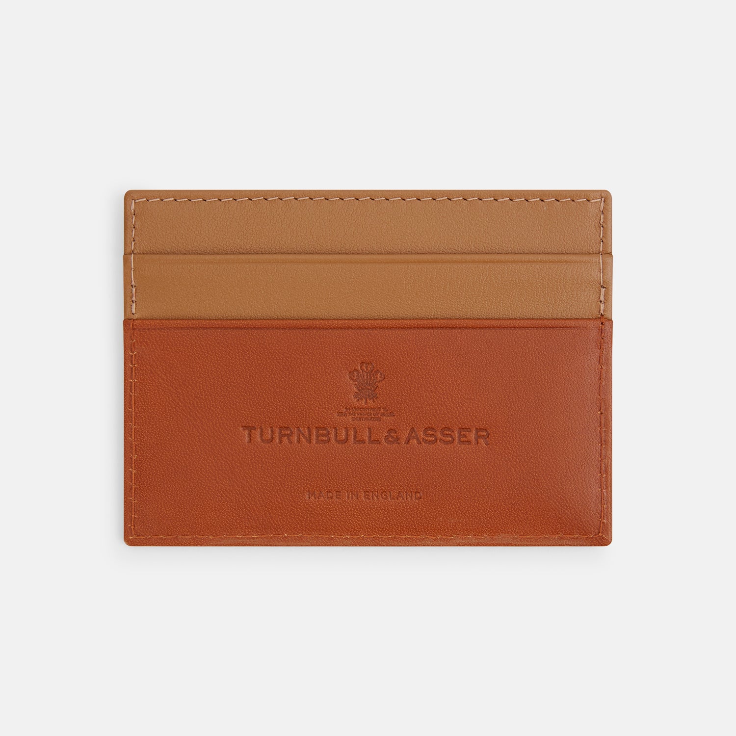 View 1 of product The TAN LEATHER CARD CASE by Turnbull & Asser is a minimalist brown leather wallet with two slots and "Turnbull & Asser Made in England" embossed on the front.
