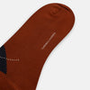 View 3 of product The Turnbull & Asser Rust Wool Check Mid-Length Sock features a brown wool design with black, gray, and orange checks, shown on a white background.