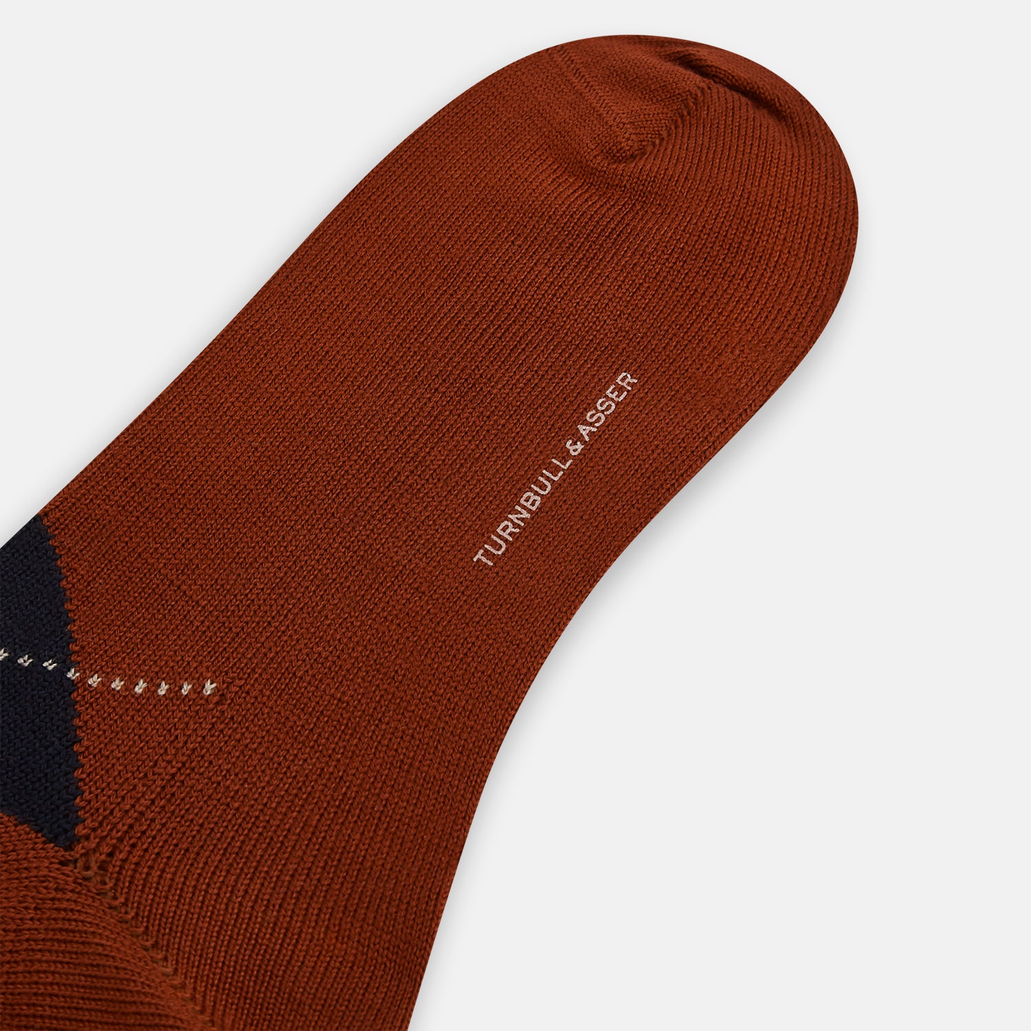 View 3 of product The Turnbull & Asser Rust Wool Check Mid-Length Sock features a brown wool design with black, gray, and orange checks, shown on a white background.