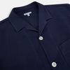 View 2 of product Turnbull & Asser Navy Silk Pyjama Set, laid flat on a white background, includes a long-sleeve button-up shirt with chest pocket and drawstring pants.