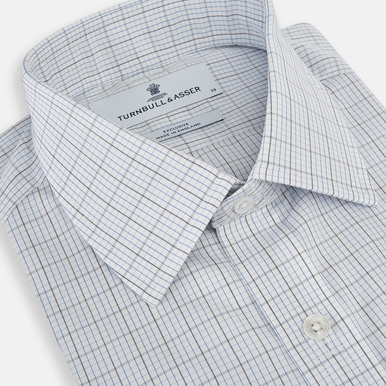 View 2 of product The Turnbull & Asser Navy and Blue Multi Grid Check Mayfair Shirt is a long-sleeve, button-up Italian cotton shirt with a collar and cuffs, featuring a blue grid check pattern, shown against a plain white background.