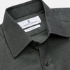 View 2 of product The Turnbull & Asser Dark Green Cotton Melange Regular Fit Mayfair Shirt features long sleeves, a T&A collar, buttoned cuffs, and a slightly rounded hem, shown laid flat on a white background.