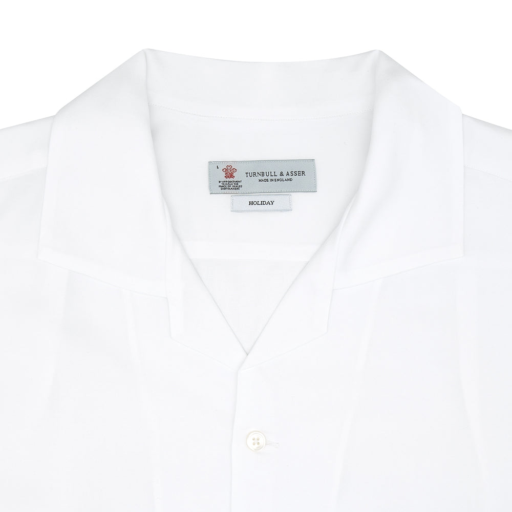 The White Lyocell Hampton Open Collar Shirt by Turnbull & Asser is neatly folded with visible label, notched collar, and buttons, displayed against a light grey background.