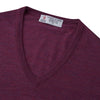 View 3 of product The Turnbull & Asser Plum Fine Merino V-Neck Jumper is a lightweight, long-sleeved layer in deep burgundy, featuring ribbed cuffs and hem for a refined finish, displayed against a white background.