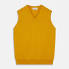 View 1 of product The Gold Ifor Cashmere Slipover by Turnbull & Asser is a sleeveless, V-neck knit in bright mustard yellow, made in Scotland and shown laid flat against a white background.