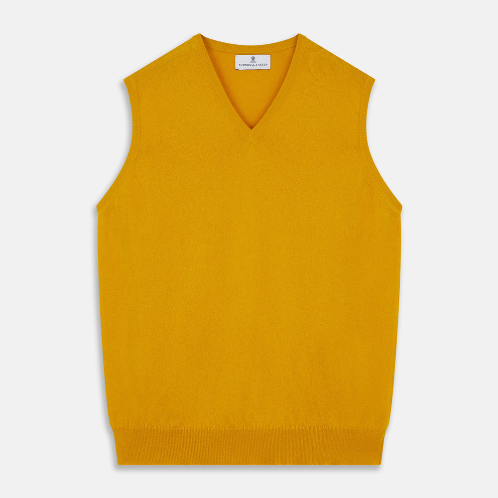 The Gold Ifor Cashmere Slipover by Turnbull & Asser is a sleeveless, V-neck knit in bright mustard yellow, made in Scotland and shown laid flat against a white background.