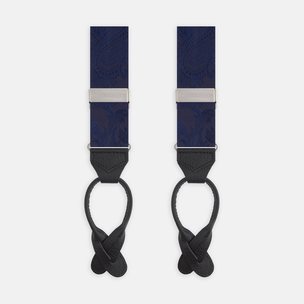 Turnbull & Asser’s Navy Paisley Adjustable Silk Braces feature subtle paisley patterns, silver hardware, and black leather ends with looped attachments, shown laid flat on a white background.