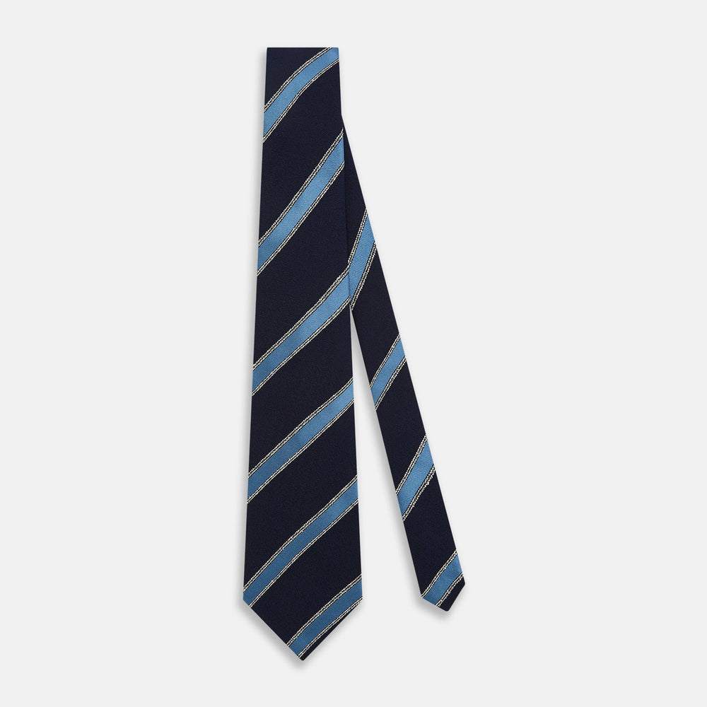The Turnbull & Asser Navy Multi Stripe Silk Tie features diagonal light blue and silver stripes on an English silk navy base, rolled neatly against a white background.