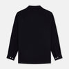 View 4 of product A Navy Cotton Holiday Fit Winnington Shirt by Turnbull & Asser, featuring long sleeves, a chest pocket, white buttons, and a revere collar, is laid flat on a white background.