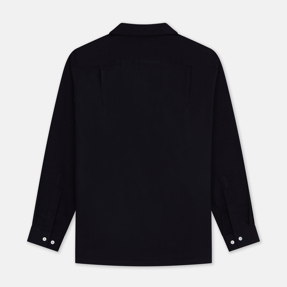 A Navy Cotton Holiday Fit Winnington Shirt by Turnbull & Asser, featuring long sleeves, a chest pocket, white buttons, and a revere collar, is laid flat on a white background.
