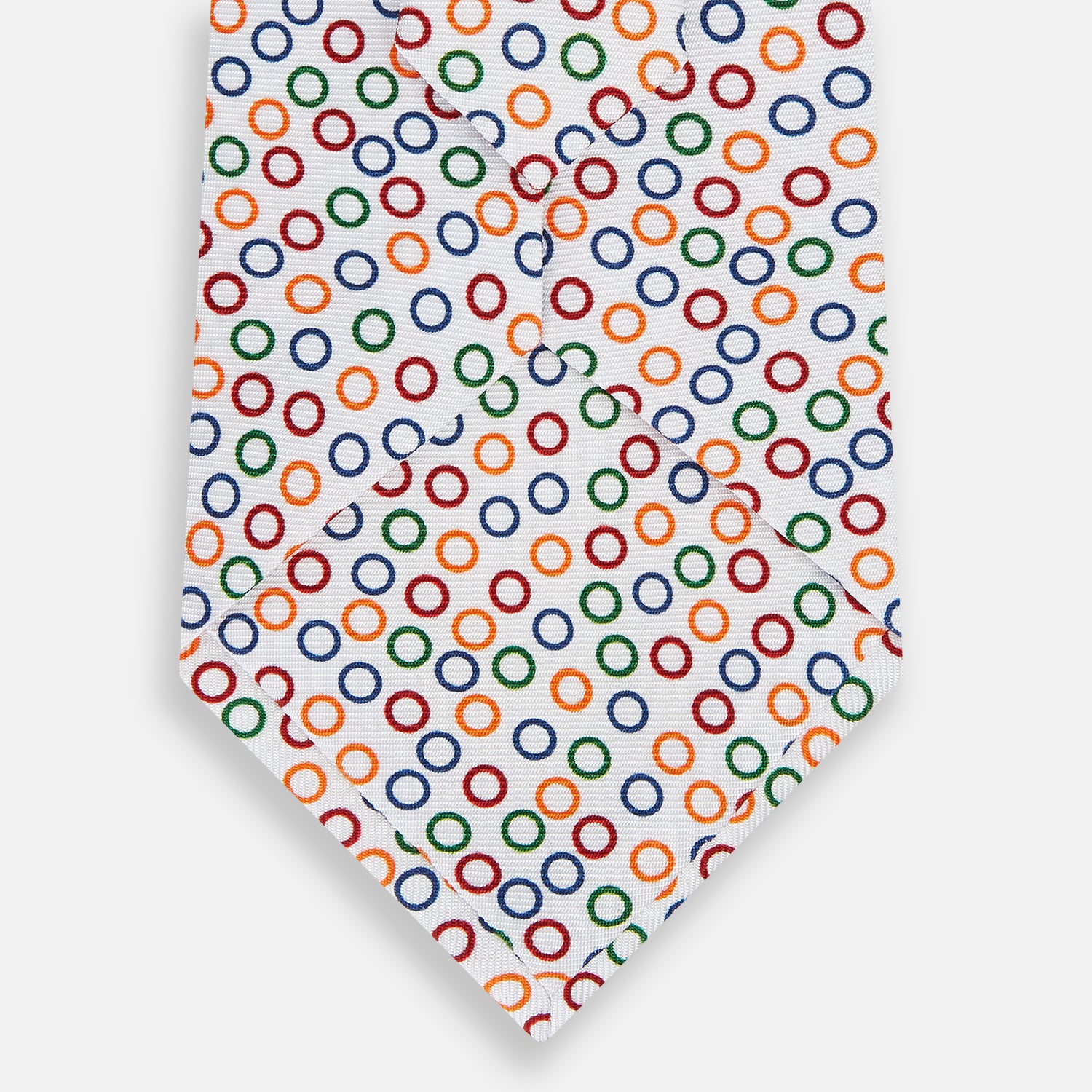 View 3 of product The Turnbull & Asser Confetti Circle White Silk Tie features colorful rings in red, orange, blue, and green scattered across a crisp white background.