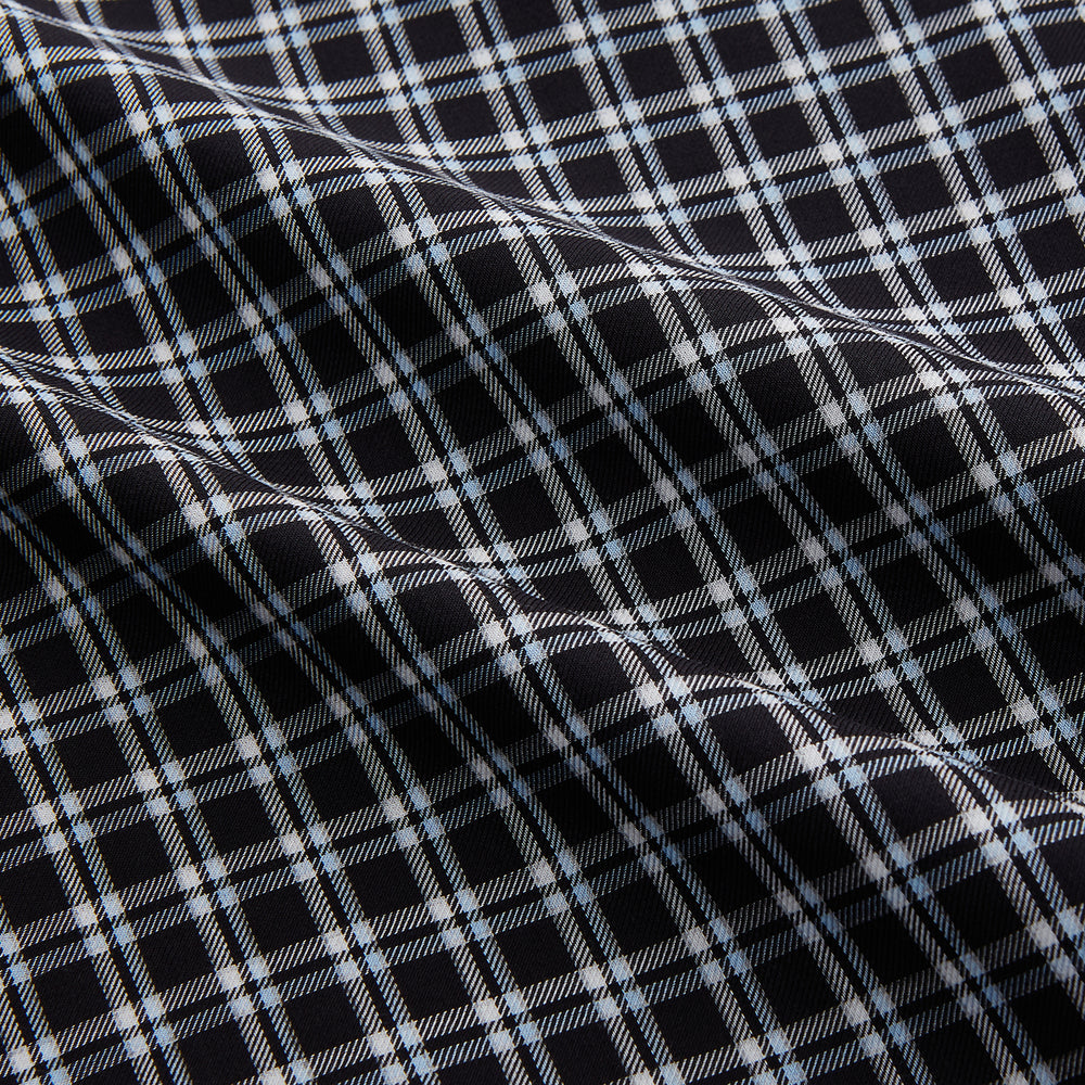 The Turnbull & Asser Black Multi Check Cotton Blend Sussex Nightshirt features a long sleeve, knee-length design with front buttons, a pointed collar, and chest pocket—ideal for those who love luxury sleepwear.