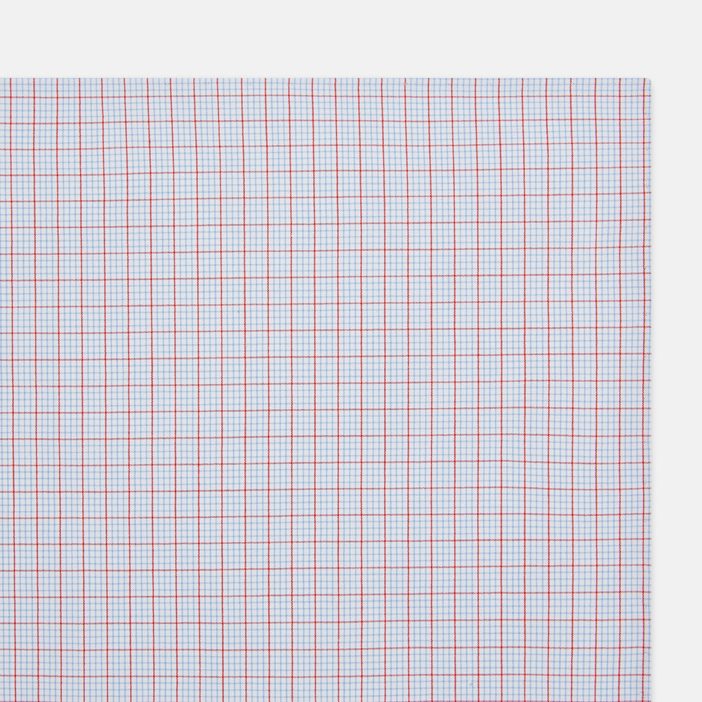 The Turnbull & Asser Hand Rolled Red Multi Graph Check Handkerchief features blue and red grid lines on white, with a red check forming larger squares and blue lines creating smaller squares within the design.