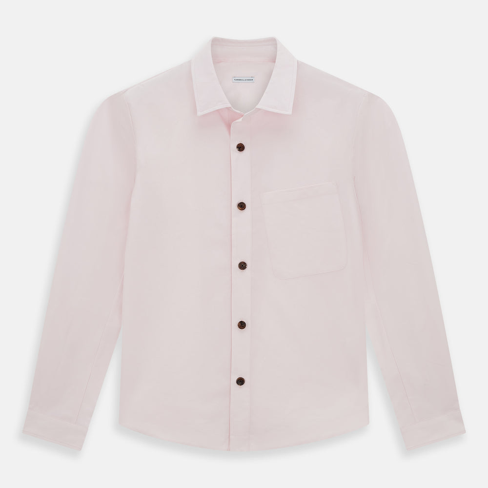 The Soft Pink Hyde Overshirt by Turnbull & Asser features long sleeves, sanforised cotton, dark buttons, and a left front pocket, shown laid flat on a white background.
