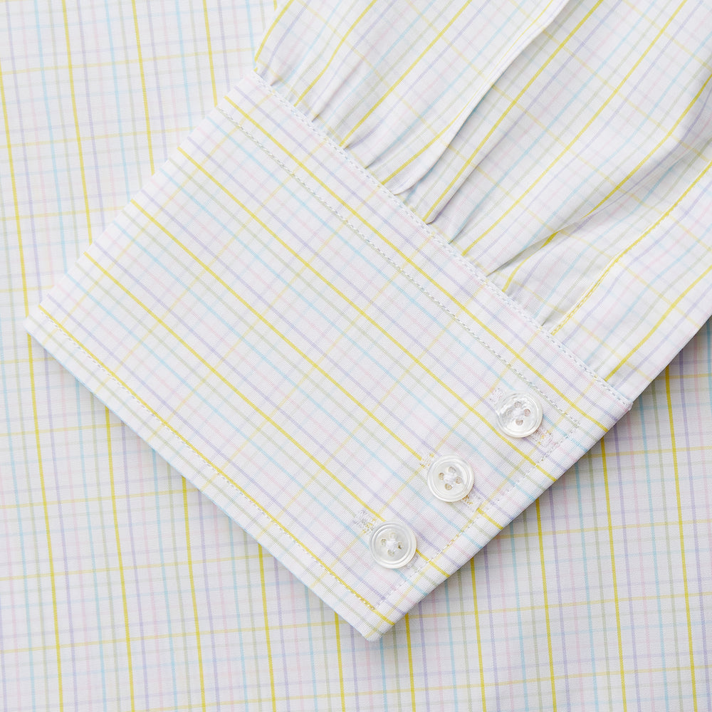 The Turnbull & Asser Yellow Multi Check Cotton Regular Fit Mayfair Shirt features a long-sleeved, button-up design with yellow and blue plaid, pointed collar, and buttoned cuffs, laid flat on a white background.
