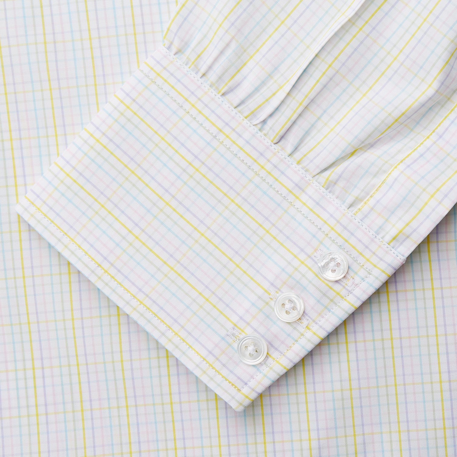 View 3 of product The Turnbull & Asser Yellow Multi Check Cotton Regular Fit Mayfair Shirt features a long-sleeved, button-up design with yellow and blue plaid, pointed collar, and buttoned cuffs, laid flat on a white background.