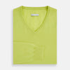 View 4 of product The Lemon Green Cashmere V-neck Jumper by Turnbull & Asser features ribbed cuffs and hem—an essential long sleeve knitwear piece, shown against a white background.
