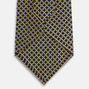 View 3 of product The Turnbull & Asser Yellow and Navy Diamond Silk Tie, with a refined yellow and light blue grid pattern, is elegantly rolled up on a plain white background.