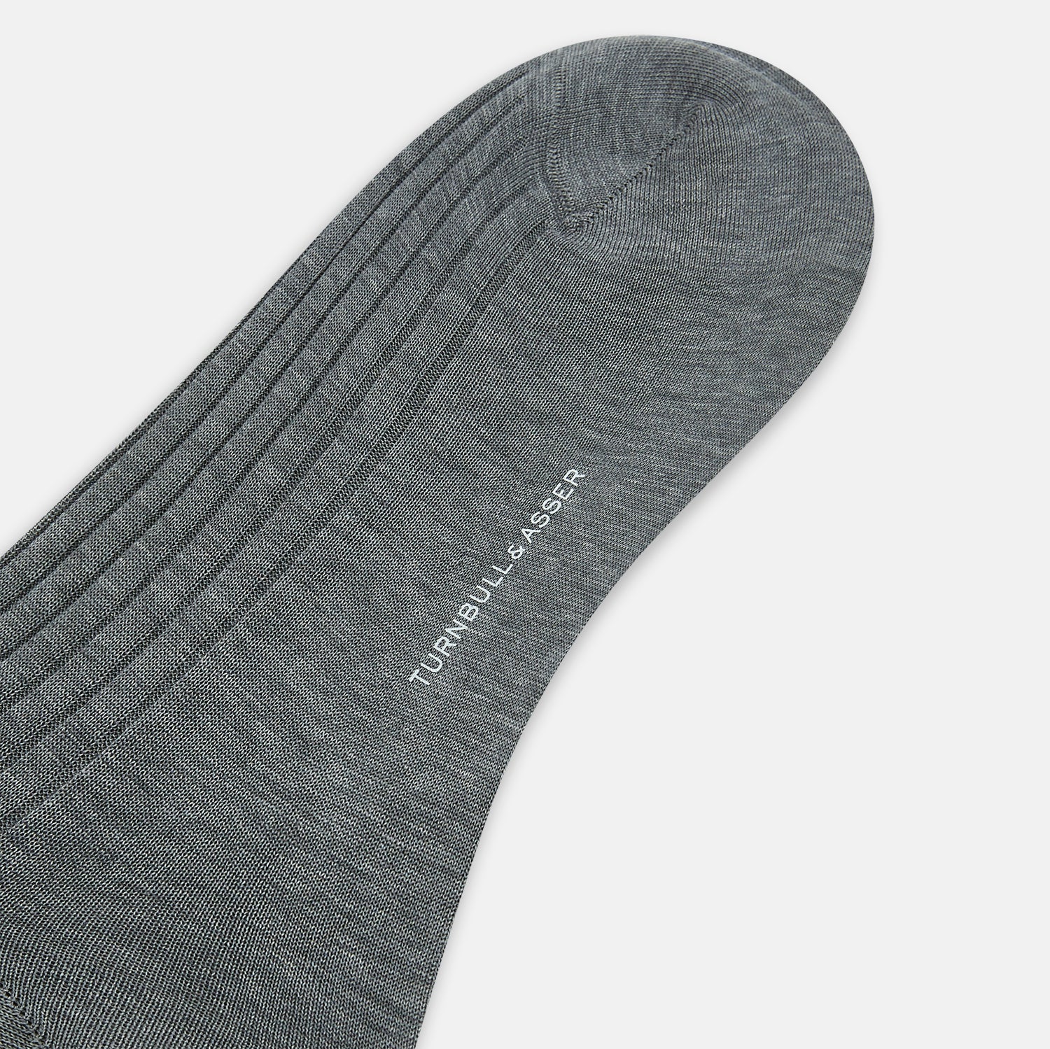 View 3 of product The Ash Long Sock by Turnbull & Asser is a single, knee-high sock in dark gray Egyptian cotton with a ribbed texture, displayed upright against a plain white background.
