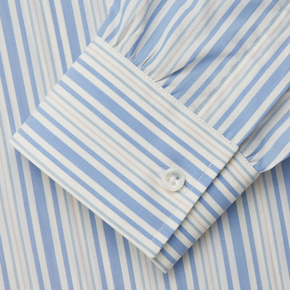 The Turnbull & Asser Blue Multi Stripe Wool Blend Weekend Fit Hayne Shirt features vertical blue, yellow, and white stripes, a button-down collar, and buttoned cuffs. Laid flat on a white background.
