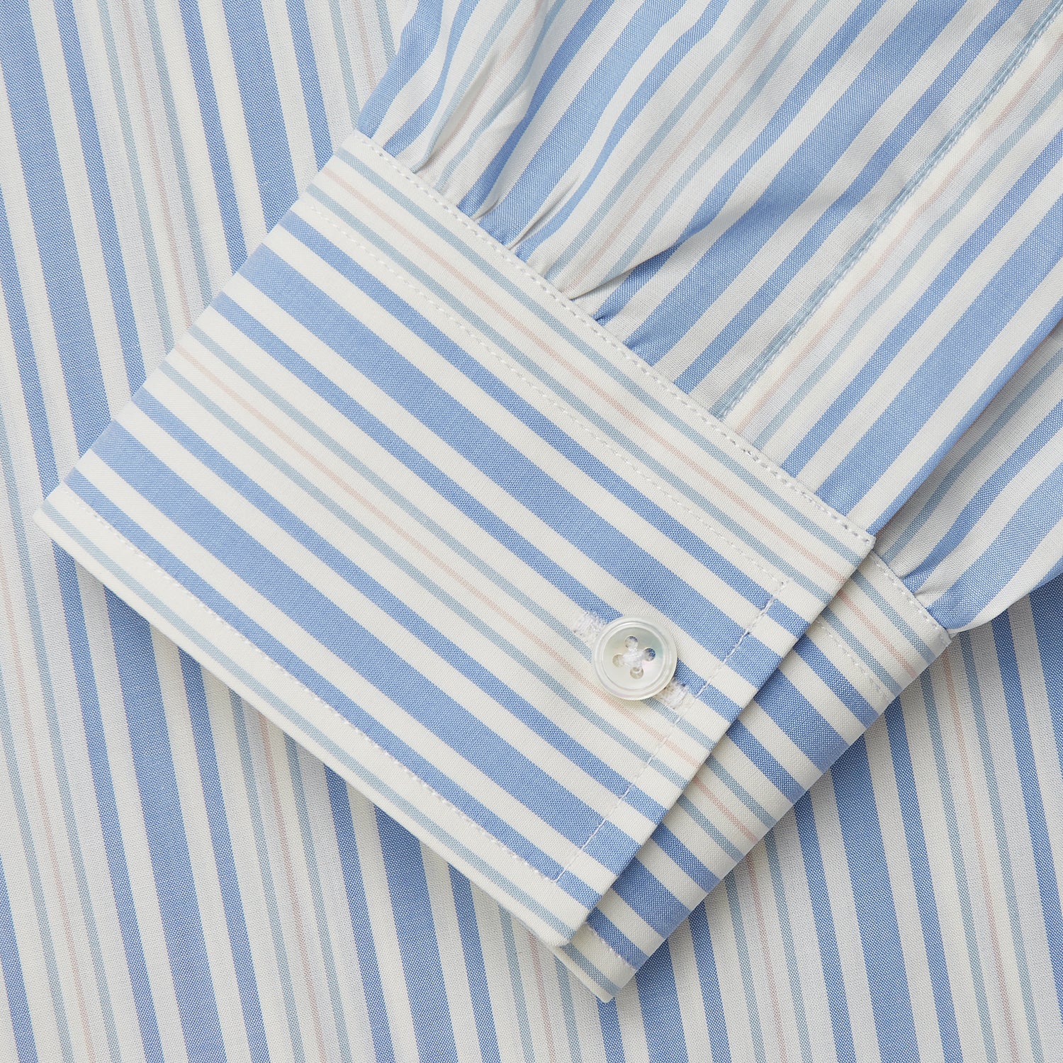 View 4 of product The Turnbull & Asser Blue Multi Stripe Wool Blend Weekend Fit Hayne Shirt features vertical blue, yellow, and white stripes, a button-down collar, and buttoned cuffs. Laid flat on a white background.