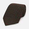 View 1 of product The Turnbull & Asser Green and Brown Micro Dot Silk Tie is shown rolled up, displaying its evenly spaced micro dot pattern against a plain white background.