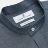 View 2 of product The Turnbull & Asser Plain Blue Oxford Cotton Weekend Fit Blake Shirt features long sleeves, a stand collar, and white buttons, displayed flat on a white background.