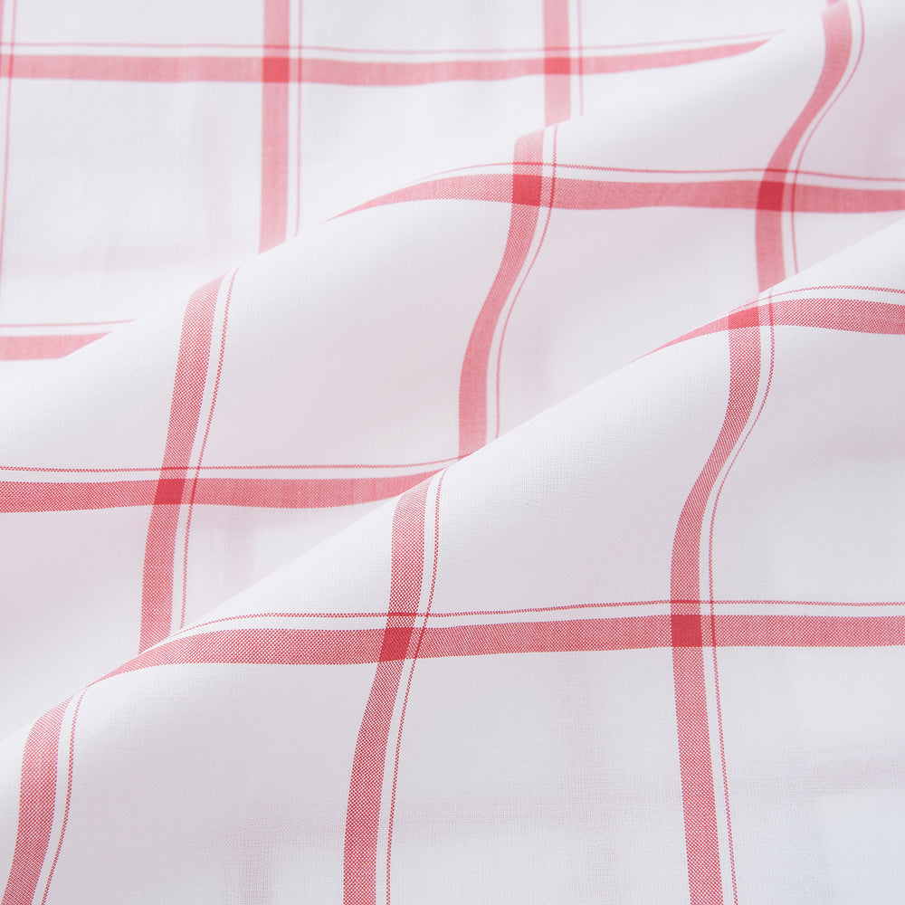 The Turnbull & Asser Coral Grid Check Mayfair Shirt is a white long-sleeve shirt with a collar, made from fine Italian cotton and featuring an evenly spaced coral grid check pattern.