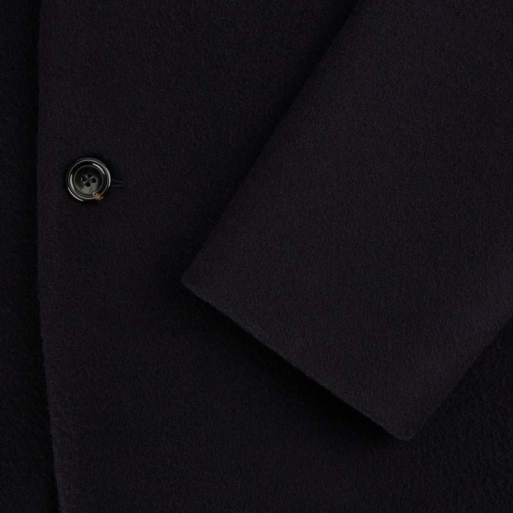 The Navy Apsley Single-Breasted Caban Coat by Turnbull & Asser features three buttons, notch lapels, a chest pocket, and two front flap pockets, shown against a plain light gray background.