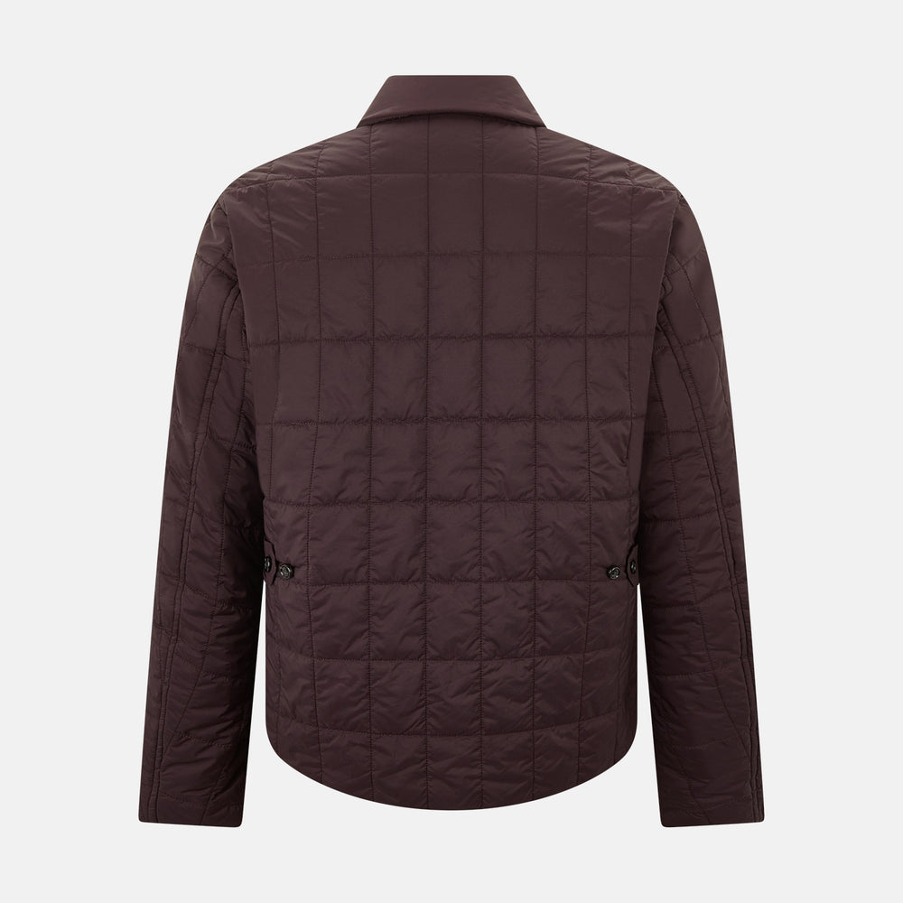 The Battersea Burgundy Quilted Jacket by Turnbull & Asser is a men's elegant outerwear featuring a front zipper, zippered side pockets, chest pocket, pointed collar, and buttoned cuffs, shown on a plain white background.