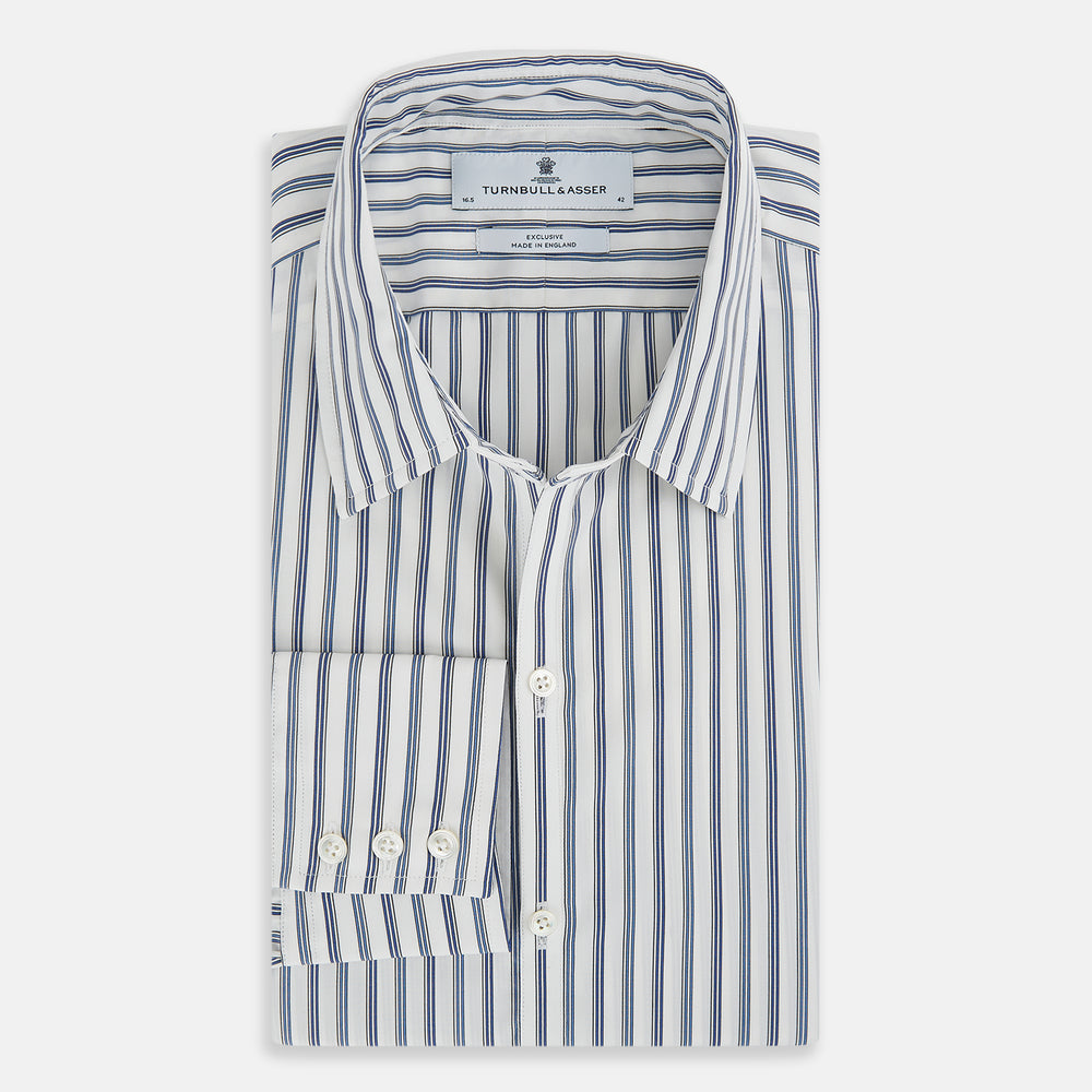 The SAPPHIRE BLUE MULTI TRACK STRIPE WINDSOR SHIRT by Turnbull & Asser features long sleeves, button-up front, classic collar, blue and white vertical stripes, buttoned cuffs, and showcases British craftsmanship on a white background.